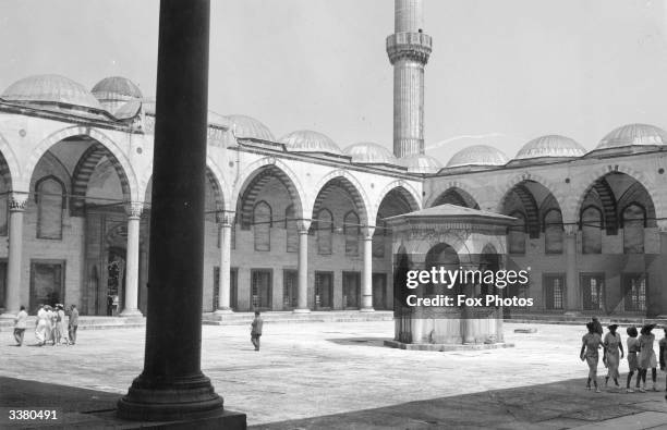 The interior of the Blue Mosque in Istanbul, with one of the minarets in the background. Built in 1609-1616, the building is named for its...