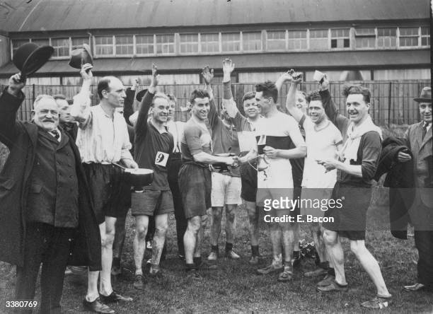 Fire Brigade Cross Country Championshipsat North Finchley, London. The winner G Frampton being congratulated by the 2nd placed man.