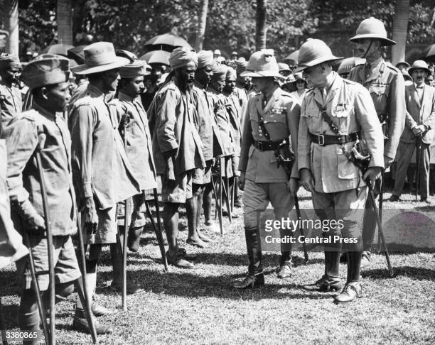 Edward the Prince of Wales, later King Edward VIII of Great Britain, inspecting maimed soldiers during a visit to Bombay, India.