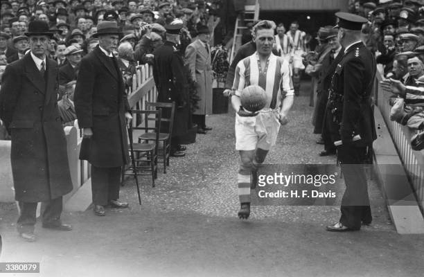 Huddersfield Town team captain, A Young, leads his team out for the FA Cup Final against Preston North End, who won 1-0 at Wembley Stadium, London.