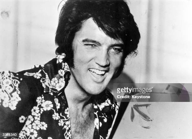 American popular singer and film star Elvis Presley , to his fans the undisputed 'King of Rock 'n' Roll'.