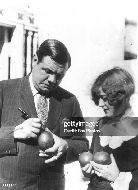 American baseball legend Babe Ruth , signing a woman's avocado pear.