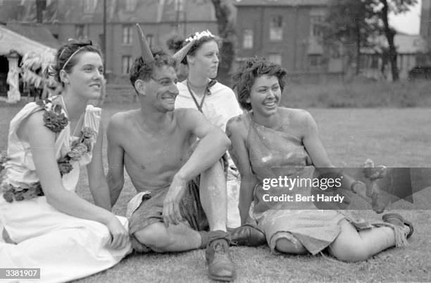 Satyr lounges around with a bevy of nymphs at the Goldsmith's Art College end of term party in London. The theme of the occasion is 'A Roman...