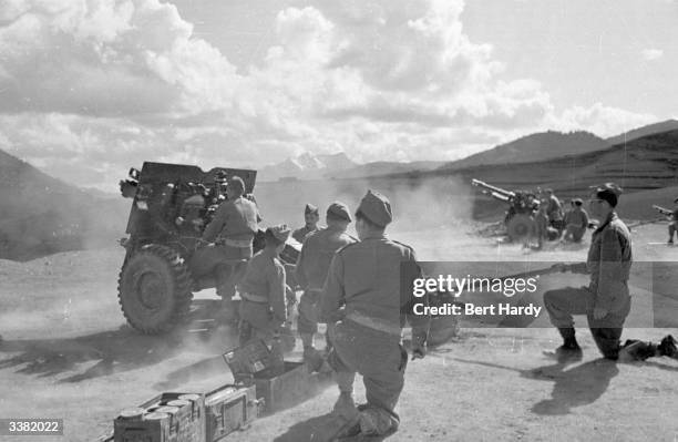 The Greek army opening fire on guerrilla troops during the Greek Civil War. Original Publication: Picture Post - 4551 - The War For Greece - pub. 1948