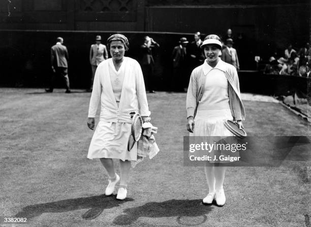 American tennis player Bunny Ryan walking onto the court with her German opponent Cilly Aussem before their women's singles semi-final match at the...