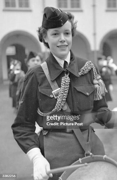 Dorothy Duff, a shop assistant and corporal in the Girl's Training Corps at weekends. Original Publication: Picture Post - 4670 - Is It True What...