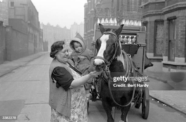 Southwark woman on her milk round near the Elephant and Castle in South London. Original Publication: Picture Post - 4694 - Life At The Elephant -...