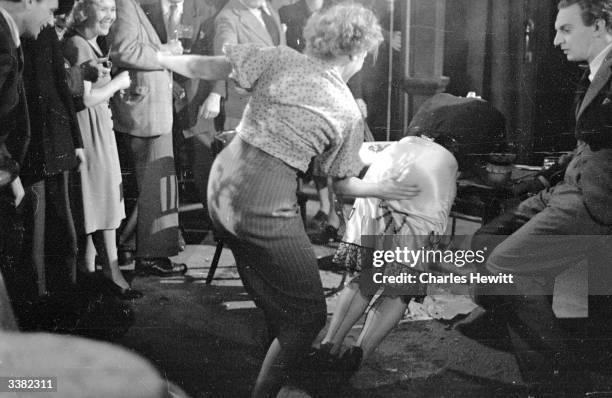 British actress Vida Hope getting her bottom smacked by Rosalyn Boulter, in a scene from the film, 'For Them That Trespass'. Original Publication:...