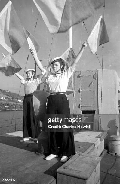 Sea-Ranger Girl Guides doing their semaphore practice on board the Motor Torpedo Boat 630 moored in the River Dart close to Dartmouth Naval College....