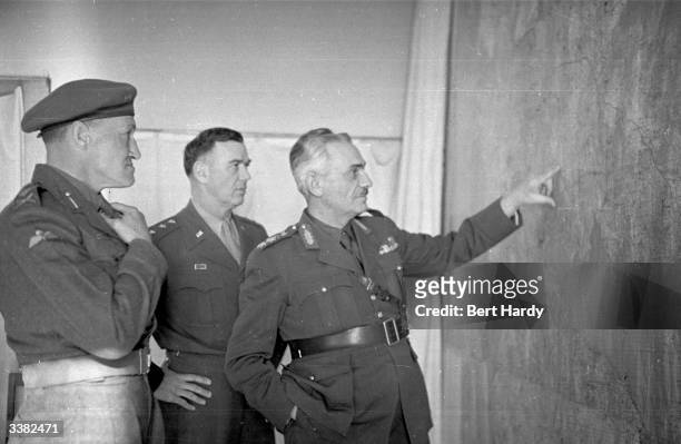 Greek commander General Vadzis holds a conference with General Van Fleet of the US and Major-General Down of Britain during the Greek Civil War. The...