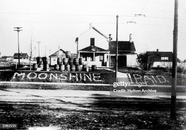 Barrels lined up by the side of a road in an American town where alcohol was found and confiscated during the Prohibition.