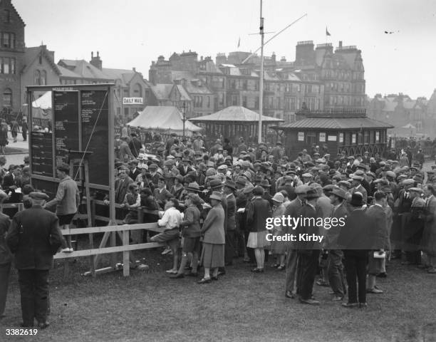 The scoreboard at St Andrews golf course in Scotland, causing much interest during a British Open Golf Championship. The Royal and Ancient golf club...