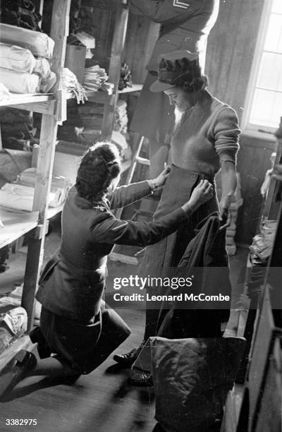 Georgy Masson from Trinidad being fitted for her uniform at an Auxiliary Territorial Services training camp. Original Publication: Picture Post -...