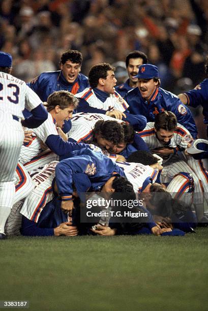 The New York Mets celebrate after winning game 7 of the 1986 World Series against the Boston Red Sox at Shea Stadium on October 27, 1986 in Flushing,...