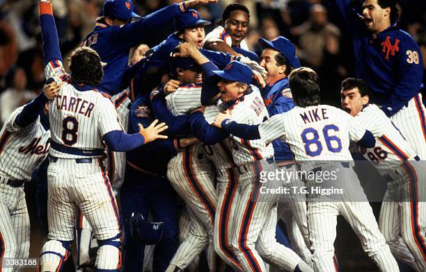 The New York Mets celebrate after winning game 7 of the 1986 World Series against the Boston Red Sox at Shea Stadium on October 27, 1986 in Flushing,...