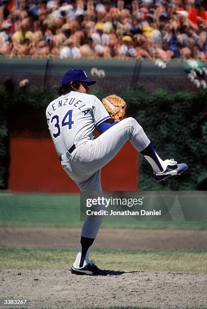 Pitcher Fernando Valenzuela of the Los Angeles Dodgers winds up for a pitch against the Chicago Cubs on June 6, 1981 at Wrigley Field in Chicago,...