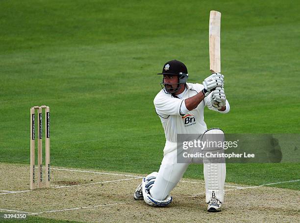 Adam Hollioake of Surrey hits out during the Frizzell County Championship match between Surrey and Sussex at the Brit Oval on April 16, 2004 in...