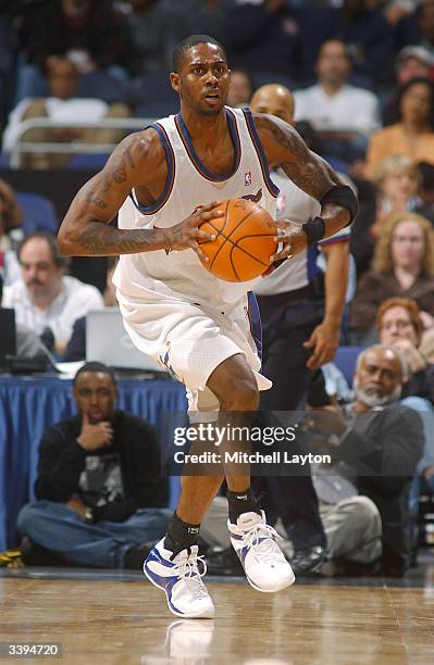 Larry Hughes of the Washington Wizards passes the ball during the game against the New York Knicks at MCI Center on April 10, 2004 in Washington,...