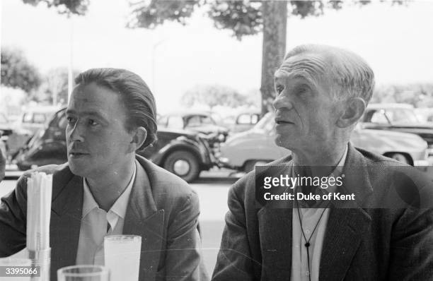'Picture Post' photographer Kurt Hutton sitting in a cafe during a business trip to Geneva, with the retained dfixer/researcherf Alex Koziell. The...