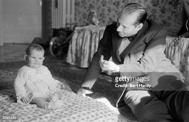 Italian film director Roberto Rossellini , with his 11-month-old daughter Isabella. Original Publication: Picture Post - 6514 - Ingrid Bergman's...