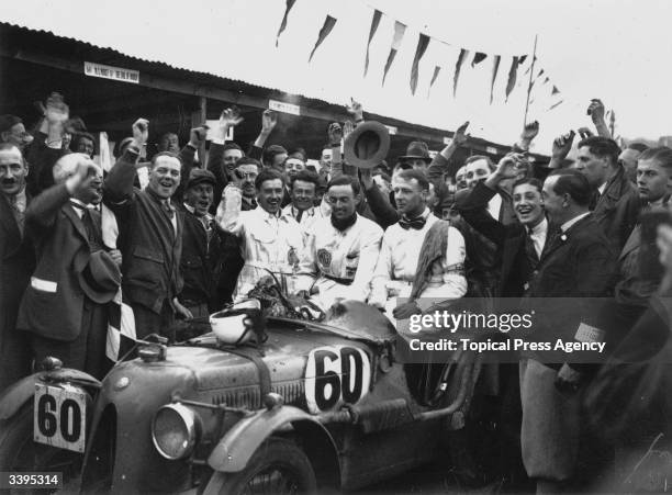 Crowd cheering the Duke of Richmond and C S Staniland, the winners of the British Double Twelve Hour race at Brooklands racetrack in Weybridge,...