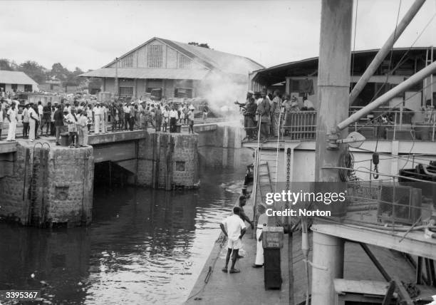 Boat drawing into port at Leopoldville, renamed Kinshasa in 1966, in the Democratic Republic of the Congo, formerly the Belgian Congo.