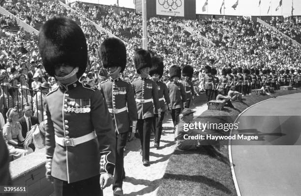 Guardsmen marching round the perimeter of the track inside Wembley Stadium during the opening ceremony of the London Olympics. Original Publication:...