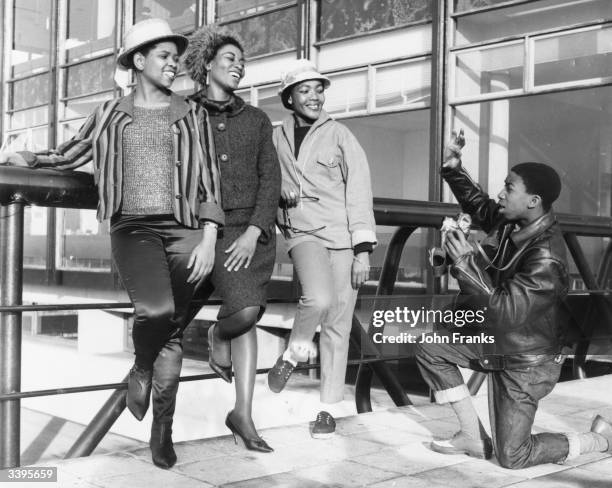 Year old photographer Lemmy Special taking a picture of three members of the cast from the all-black South African musical 'King Kong', before they...