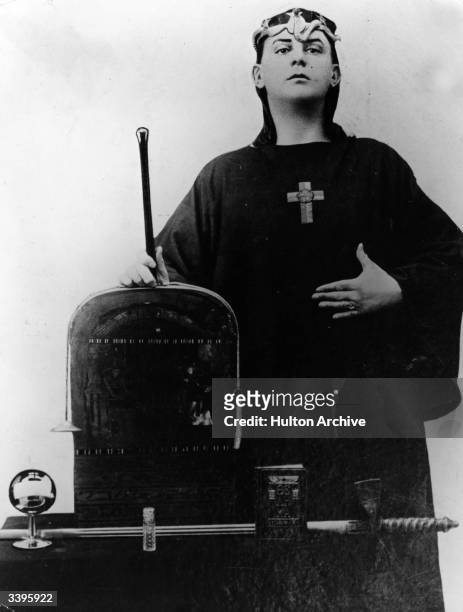 English author magician and occultist, Aleister Crowley with a selection of occult instruments.