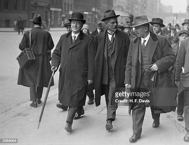 British Labour Leader of the Opposition, Ramsay MacDonald , leaving Memorial Hall, London with Labour MPs, Arthur Henderson and J. H. 'Jimmy' Thomas...