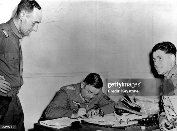 General Dietrich von Choltitz, the Nazi commander of Paris, signing the surrender of the Nazi troops after the French capital's liberation.