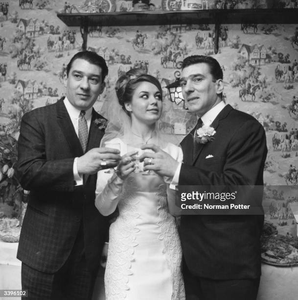 Frances Shae toasting to future happiness with the Kray twins, after her marriage to Reggie Kray, right.