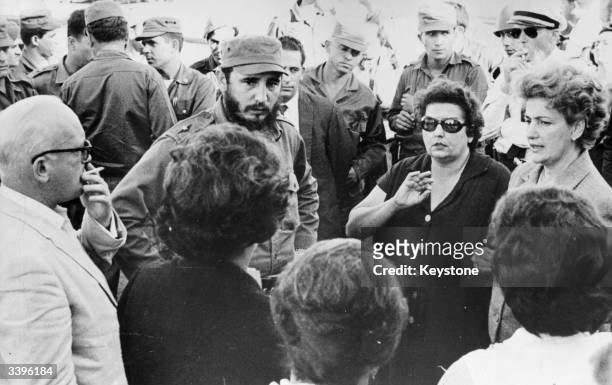 Cuban prime minister Fidel Castro talking with parents of some of the American prisoners held hostage for food and supplies by the Cuban government...