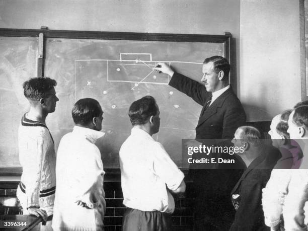 Football referee S F Evans describing the off-side rule with the aid of a blackboard to public schoolmasters at Mill Hill School, London.