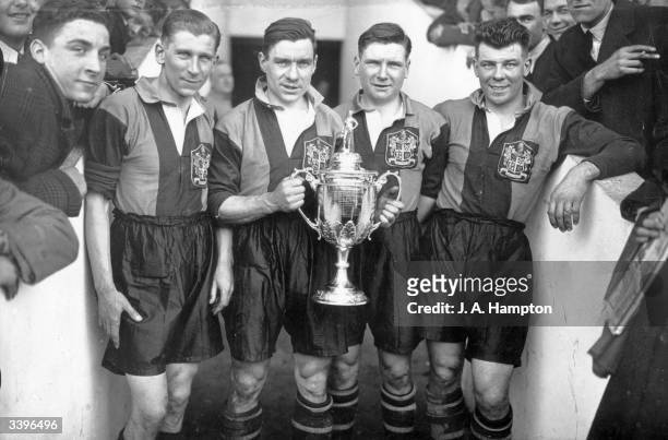 Dulwich Hamlet FC football players hold the FA Amateur Cup at Upton Park, London. Left to right C Murray, H Robbins, L Morrish and A Hugo.