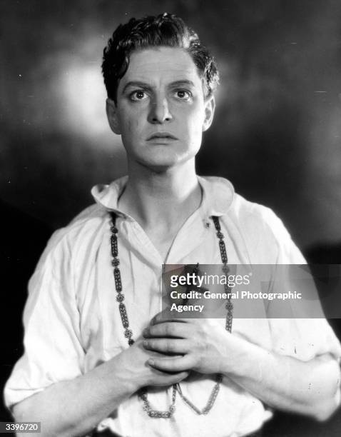 British actor Robert Donat clutching crucifix in his role as Martin in The Witch at the Embassy Theatre, London. The play was translated from the...
