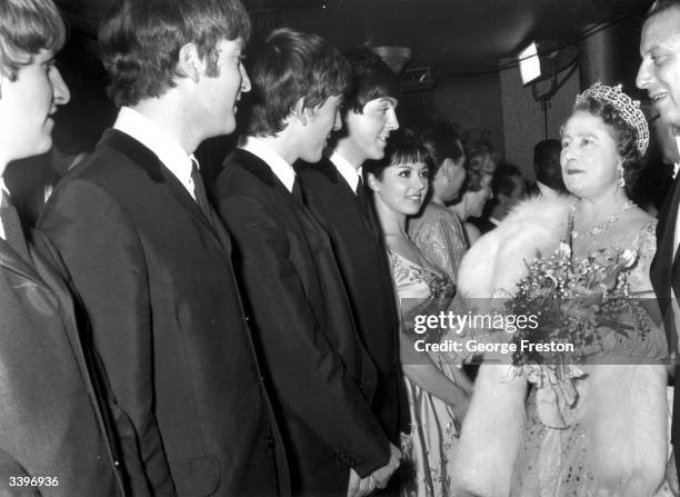 Queen Elizabeth The Queen Mother talking to British pop group The Beatles after a Royal Variety Show at the Prince of Wales Theatre, London.