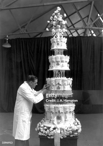 Mr Schur, chief confectioner at McVitie and Price, putting the final touches to the wedding cake of Princess Elizabeth and The Prince Philip, Duke of...