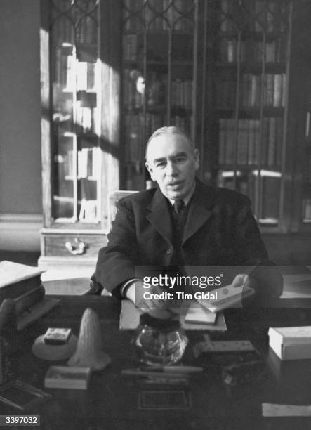 John Maynard Keynes , the British economist, whose theories profoundly influenced much government economic policy, at work in his study in...
