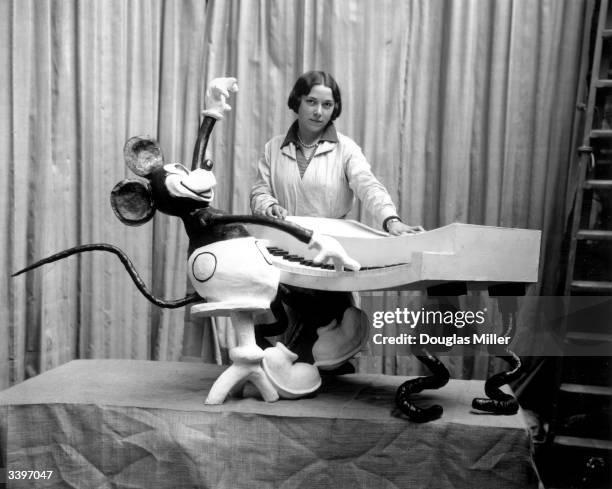 An employee at Madame Tussaud's waxworks museum on Marylebone Road, London, putting the finishing touches to a waxwork of Mickey Mouse at the...