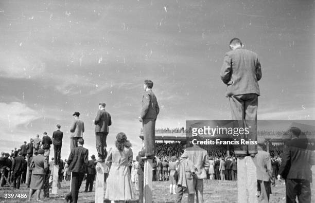 Race-goers standing on posts for a better view at the Galway Races. Original Publication: Picture Post - 2082 - Off To The Galway Races - pub. 1st...