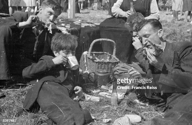 Race-goers having a lunchtime picnic at the Galway Races, Ireland. Original Publication: Picture Post - 2082 - Off To The Galway Races - pub. 1st...