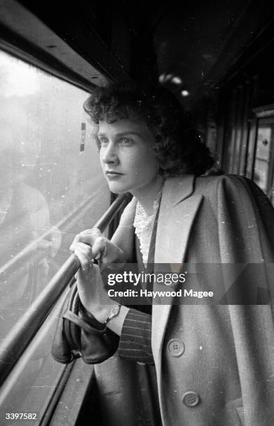 American film actress Kim Hunter looks longingly out of a train window on her journey from Baltimore in the USA, to England to star in a film, 'A...