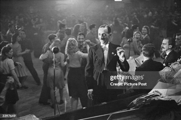 Lou Preager and his band perform at the Hammersmith Palais de Danse, to a crowd of dancing London youth. Original Publication: Picture Post - 1895 -...