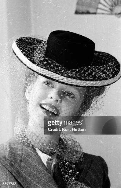 Star of 'Junior Miss' Peggy Cummins modelling a hat which she made herself from a design by Rose Bertin. Original Publication: Picture Post - 1551 -...