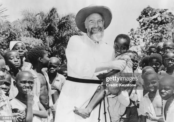 French missionary Father Durand with parishoners in Mongali, near Brazzaville in the Belgian Congo, now the Republic of Congo.
