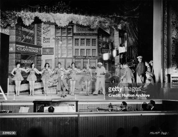 James Cruze directs a vaudeville dance team for a scene in the MGM film 'Excess Baggage'. On the right is actress Josephine Dunn who plays the lead.