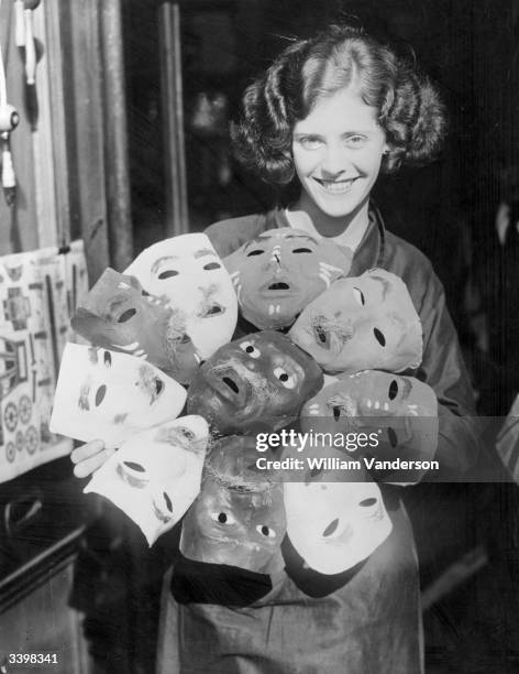 An assistant at a shop in Slough, Berkshire, with a selection of Guy Fawkes masks.