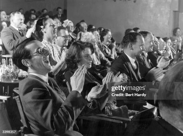 Members of an audience at the Players' Theatre at Hungerford Arches, London, watching a production based on the Victorian Music Hall. Original...