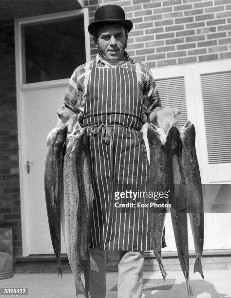 Fisherman John Batchelor shows off the six salmon, weighing over 70lbs, that he caught at Mudeford, Hampshire.